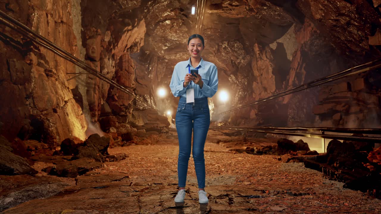 Full Body Side View Of Asian Female With Her Laptop In Underground Mine Tunnel, Typing On Her Laptop'S Keybaord With Meditation
