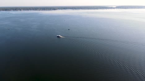 a boat travelling on the surface of muskegon lake