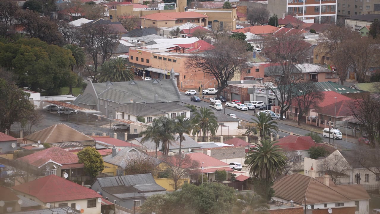 Una vivace vista dell'area residenziale colorata di Johannesburg, con tetti vivaci e traffico stradale intenso. Adatto per servizi sullo sviluppo urbano o documentari sulla vita cittadina.