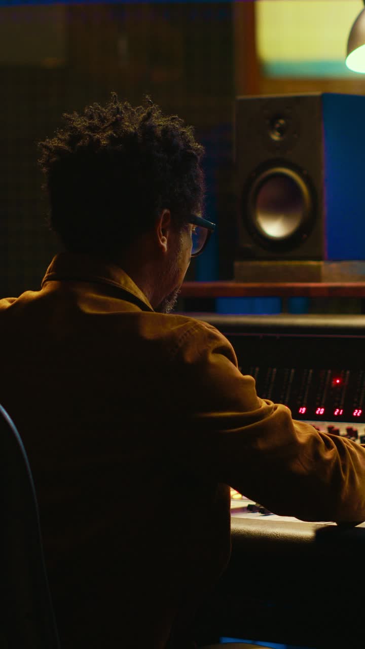 Man Working on Audio Mixing Console in Recording Studio