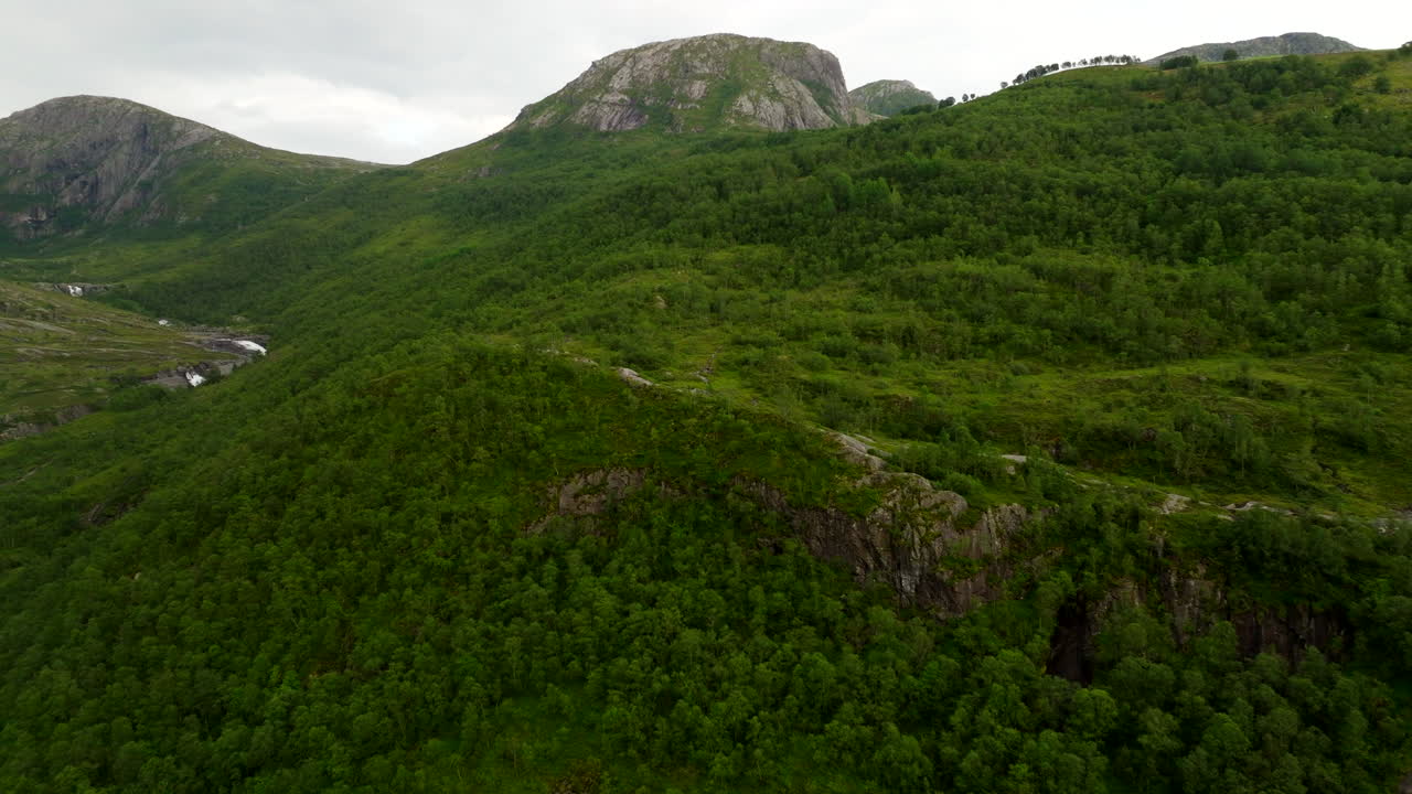 Lush green mountains and valley, beautiful landscape in southwestern Norway. Aerial drone