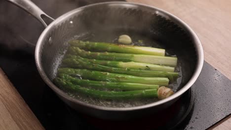 frying asparagus in a pan