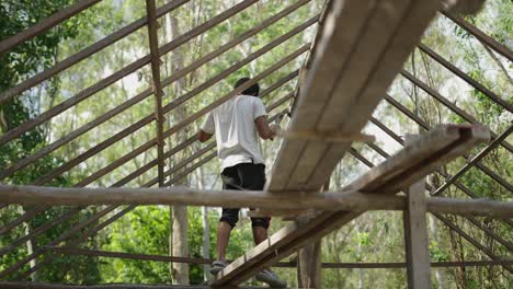 man working on a wooden roof frame outdoors