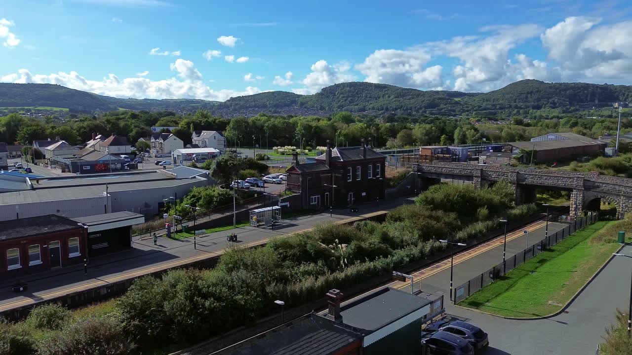 Penrhos and Abergele aerial view circling above the sunny coastal beachfront railway station