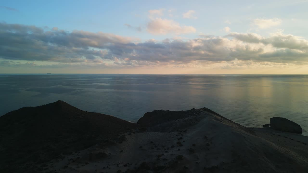 Aerial View of Coastal Landscape with Ocean and Sunrise Sky