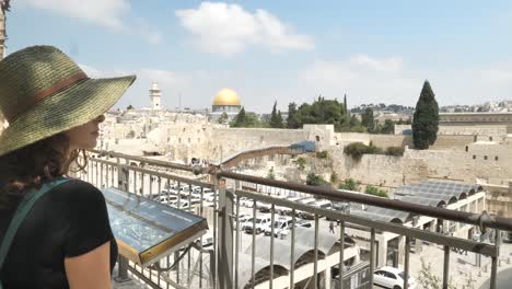 Female-tourist-in-straw-hat-looking-at-Temple-Mount-in-Jerusalem,-Israel