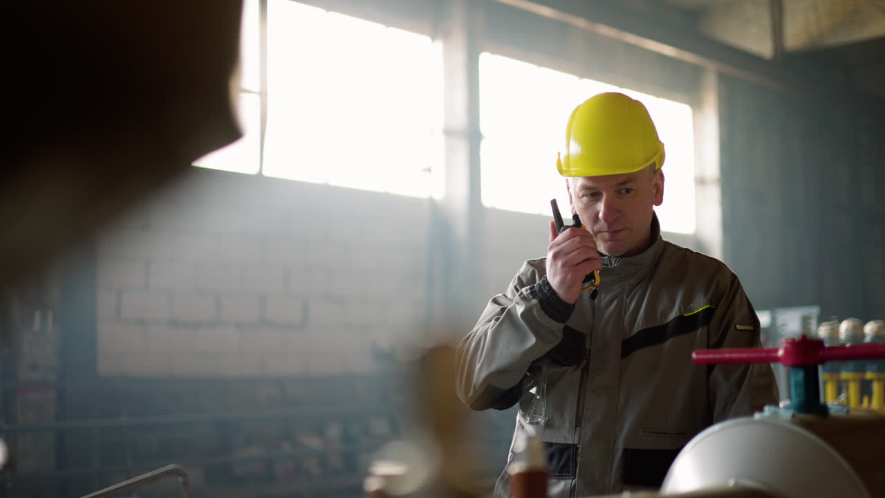 Man with yellow hardhat at the factory