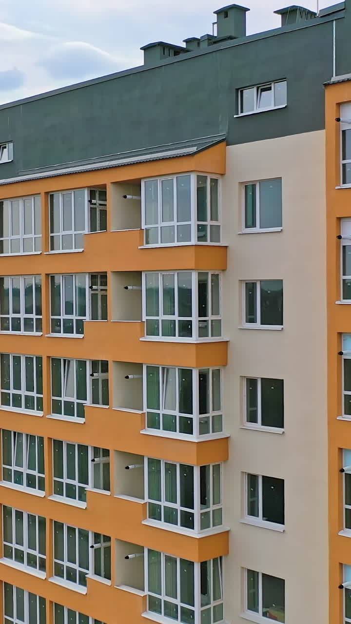 Multi-story building exterior with orange and beige facade