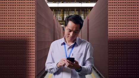 business person checking inventory in a brick factory