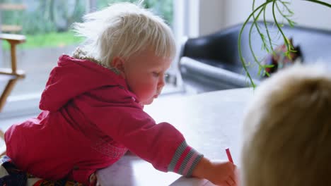 siblings drawing with crayons on paper at home 4k