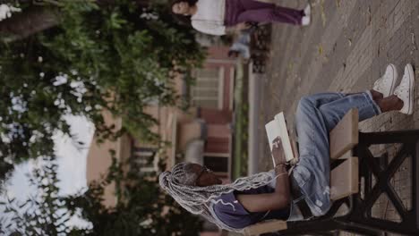 Woman with Braids Reading on a Park Bench