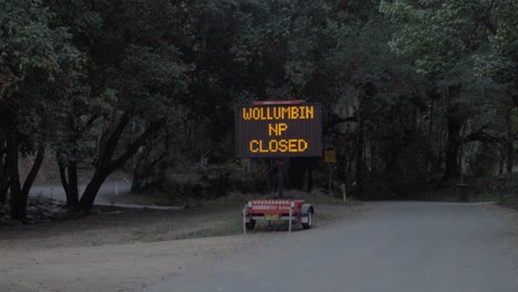 electronic led wollumbin national park closed road sign in mount warning, nsw, australia - closed due to coronavirus