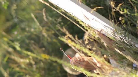 an artist paints a picture on a sunny summer day in a meadow an artist paints a picture on a sunny summer day in a meadow artist girl draws nature