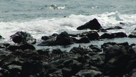 waves lapping the rocky shore of the african island nation of são tomé and príncipe