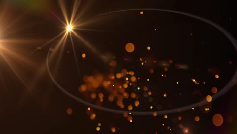 Glowing-orange-sparks-of-light-and-spot-of-light-against-black-background