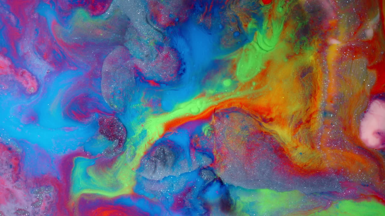 Colorful swirling ink patterns in water, vibrant and abstract with a smooth flow