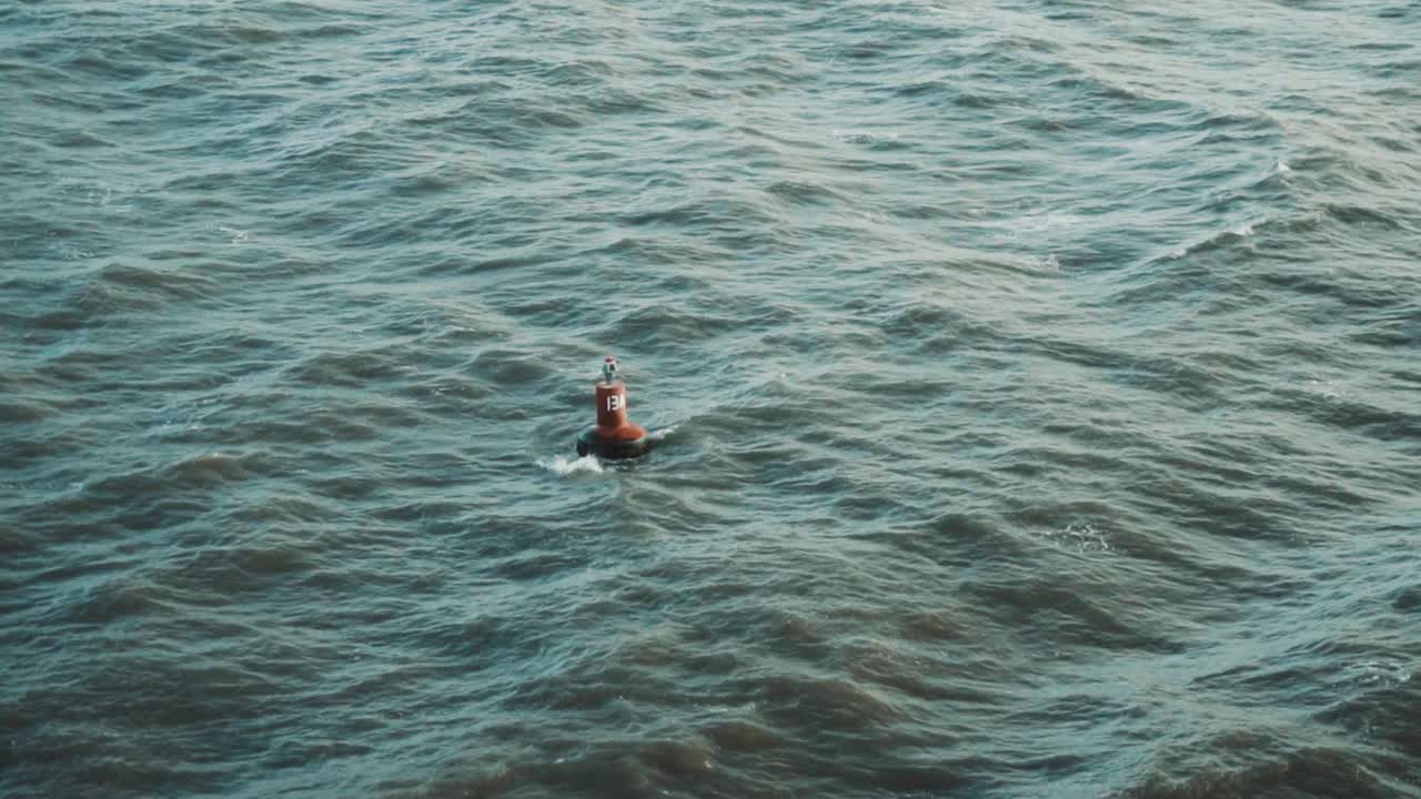 Slow motion shot of a buoy a floating in the Indian ocean.