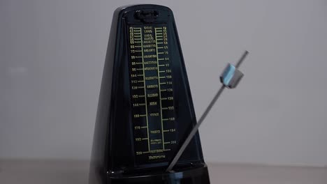 regular metronome swinging to beat of music, close up