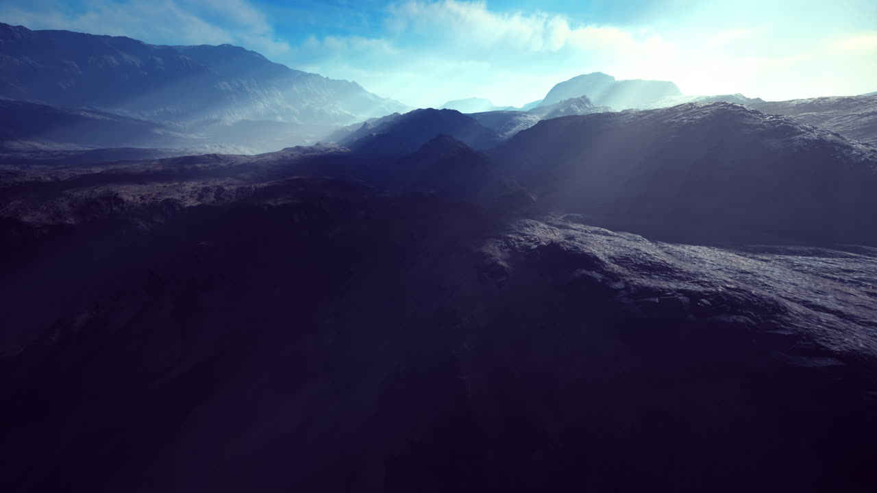 Majestic mountain landscape with sun rays shining across the rugged terrain