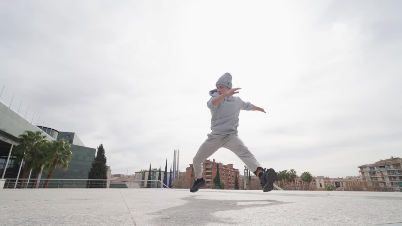 Breakdancer performing cartwheel in urban environment