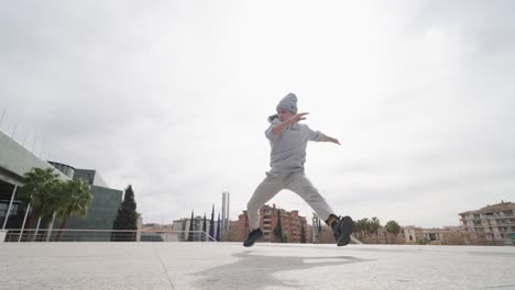 breakdancer performing cartwheel in urban environment