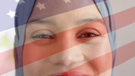 animation of flag of usa over biracial woman in hijab drinking tea