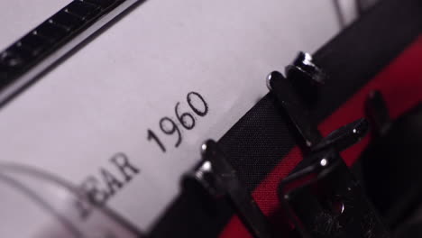 year 1960, typing on white paper in vintage typewriter, close up