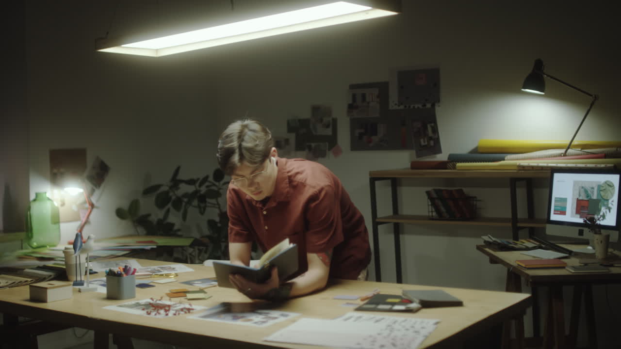 Man working on creative projects in his studio at night