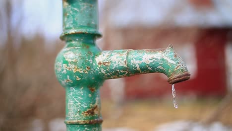 old rural hand pump is operated in slow motion