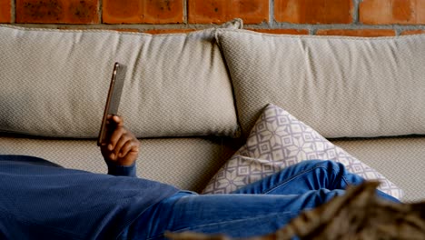 senior man using digital tablet in living room 4k