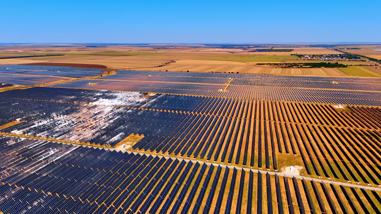Solar farm with sunlight reflections on panels. Shiny solar panels reflecting the sun in a massive renewable energy farm