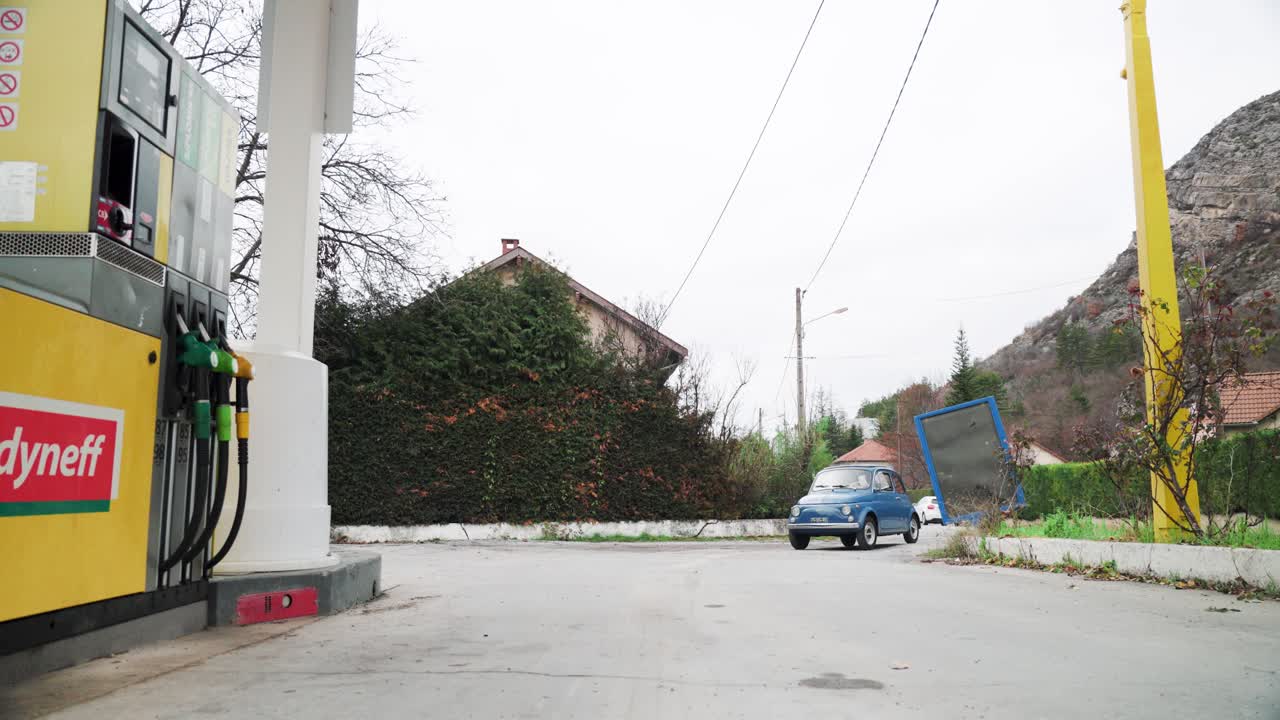 Couple Driving a Classic Fiat 500 on a Scenic Road Trip