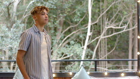 young man enjoying peaceful moment outdoors on balcony surrounded by nature, copy space
