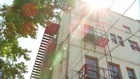 establishing shot of an apartment building with fire escapes