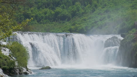 A-waterfall-with-a-large-amount-of-water-on-a-clean-and-wild-mountain-river