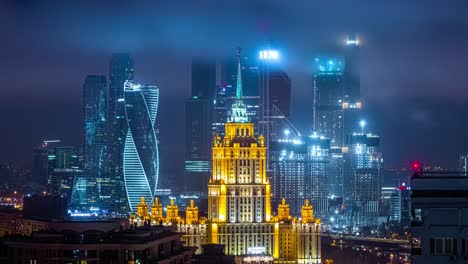 Time-lapse-of-the-cloud-moving-over-tall-building-in-the-city-at-night