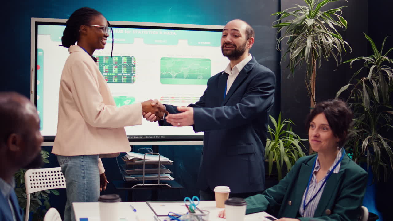 Business manager does handshake with a new employee during a briefing meeting