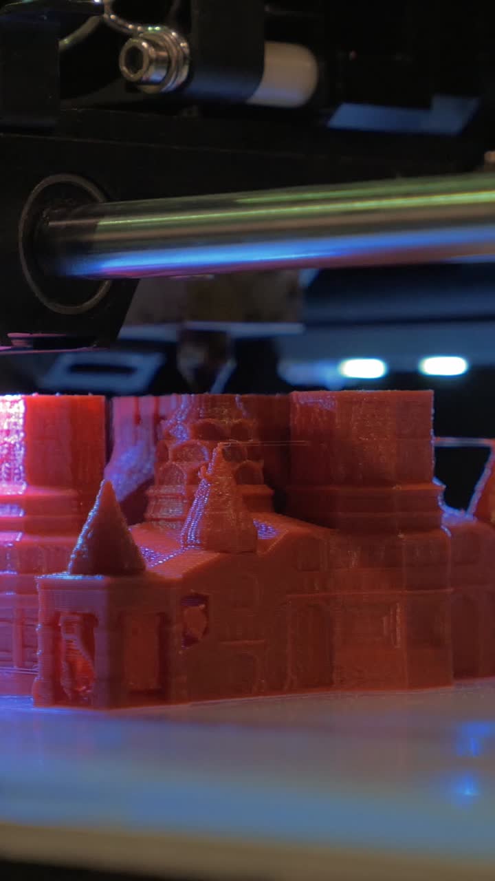 Close Up of 3D Printer Creating a Red Plastic Model