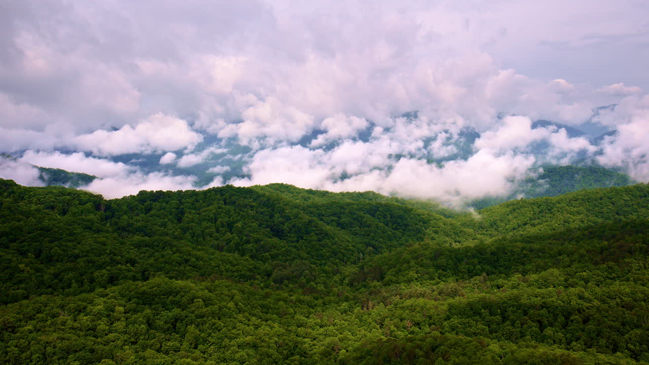 Cloud-veiled peaks in this cinematic aerial view.
