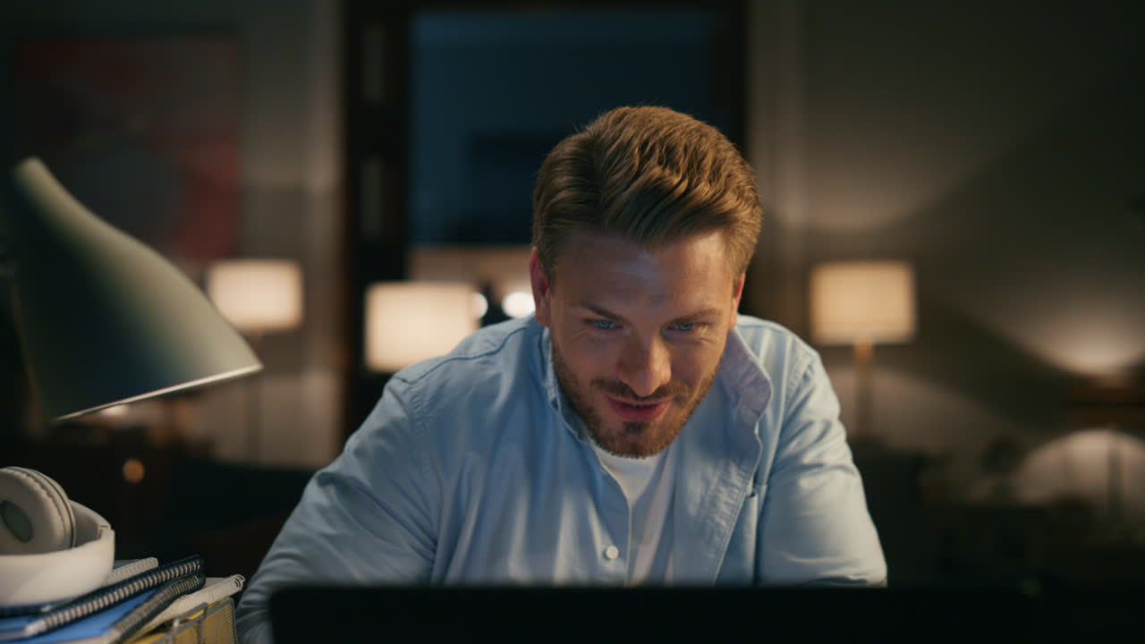 Laughing guy chatting computer cozy apartments closeup. Person reacting on joke