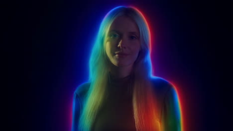 blonde woman bathed in vibrant rainbow light