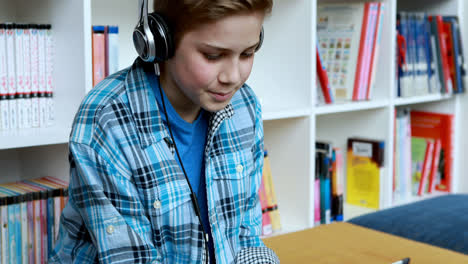 student using digital tablet in library