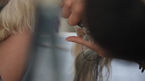 Female-groomer-clipping-nails-of-a-dog-n-closeup,-slow-motion