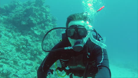 diver shows okay sign great dive and vacation