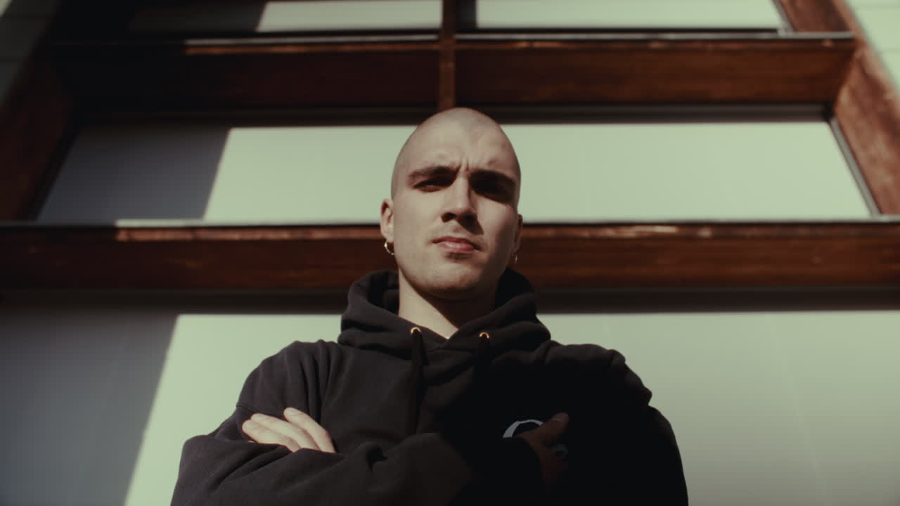 Man in Hoodie in front of Building