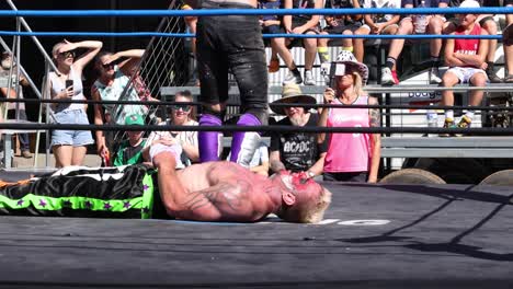 wrestlers compete in an outdoor wrestling ring