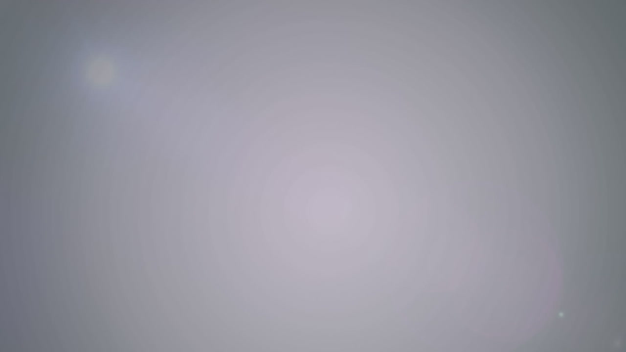 Animation of colourful light spots moving over gray background