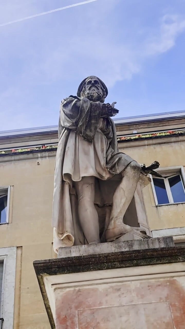Veduta verticale dal basso della statua del Parmigianino a Parma, Italia, che raffigura il pittore rinascimentale Francesco Mazzola sopra il suo monumento del 1879 opera di Giovanni Chierici