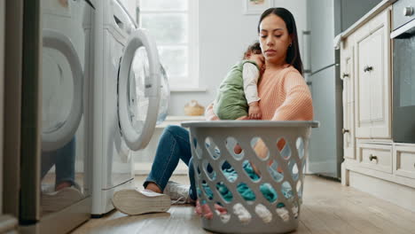 Woman-holding-baby,-laundry-and-basket