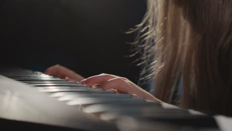 piano keys feel touch of girl fingers. gifted girl delves into intricacies of melody during musical lesson in audio studio. musical talent of children